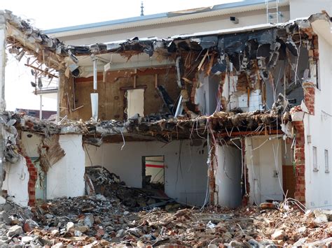 destroyed metal houses|demolition of building materials.